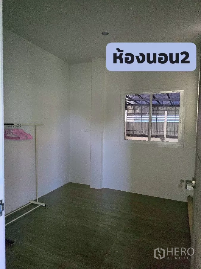 Warehouse for rent or sale in Khlong Toei, Bangkok - Compact second bedroom with window and clothes rack.