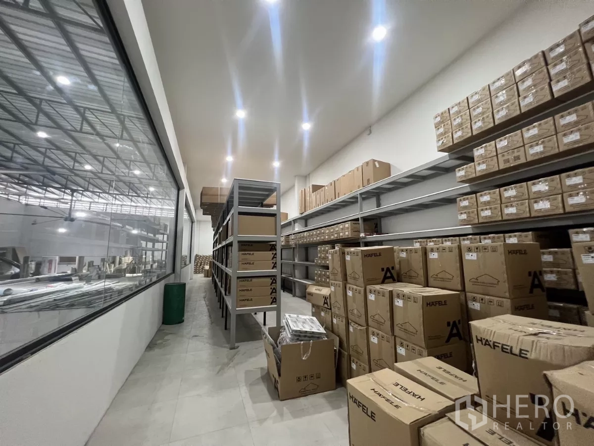 Warehouse for rent or sale in Lat Krabang, Bangkok - Long storage corridor with racking systems and boxed inventory.