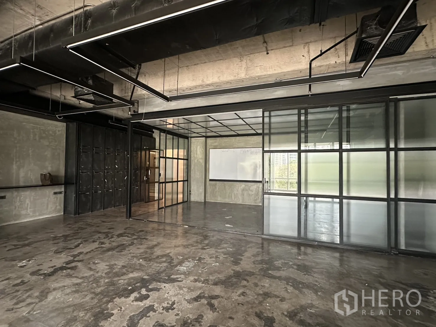 Office Space for rent in Pathum Wan, Bangkok - Large office area with exposed ducting, linear lights, and frosted glass partitions.