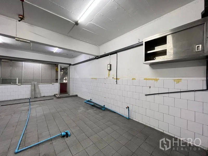 Shophouse for rent - Large prep kitchen area with tiled floor, plumbing and ventilation lines.