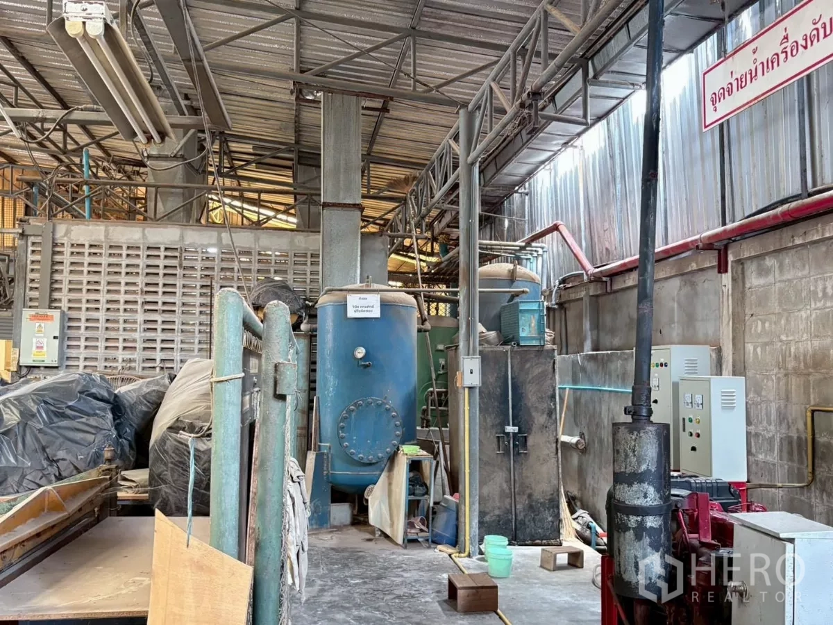 Factory for rent or sale in Bang Khun Thian, Bangkok - Machinery zone with tanks and ventilation pipes inside the production area.