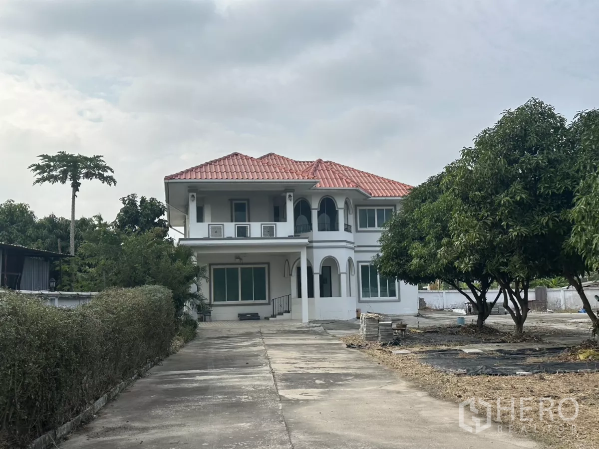 Home Office for rent - Front view of a two-storey house with red tile roof, long driveway and mature trees.