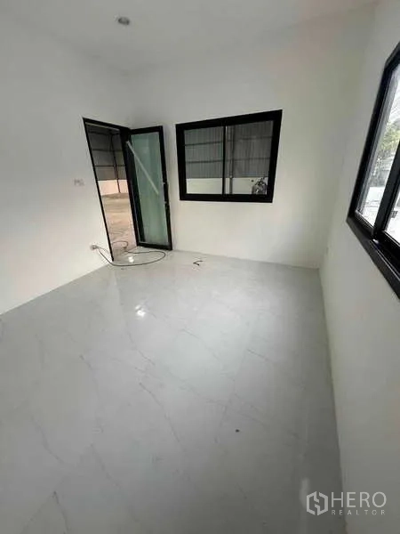 Warehouse for rent in Bang Khen, Bangkok - Bright office room inside the warehouse with glass door and window overlooking the storage area.
