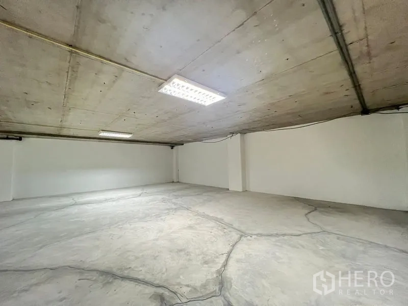 Office Space for rent - Bright blank workspace with low exposed ceiling and smooth concrete flooring.