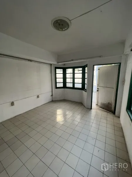 联排别墅 出售在Watthana, Bangkok - 一层起居区，设有飘窗与通向前院的房门。