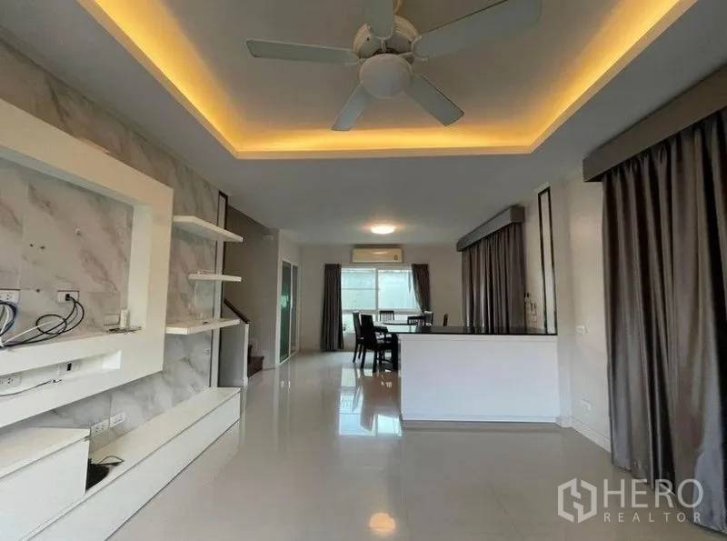 Detached House for sale in Bang Phli, Samut Prakan - Open-plan lounge with recessed lighting, ceiling fan, built-in shelves and glossy floors.