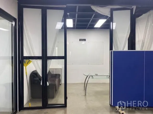 Home Office for rent or sale in Bang Khae, Bangkok - Meeting room with glass doors, sofa corner and ceiling lights.