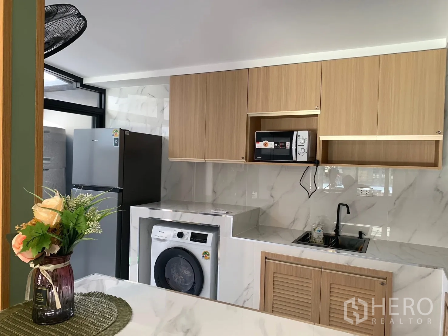 Townhouse for rent in Bang Phli, Samut Prakan - Appliance corner with fridge, washing machine, sink and overhead cabinets.