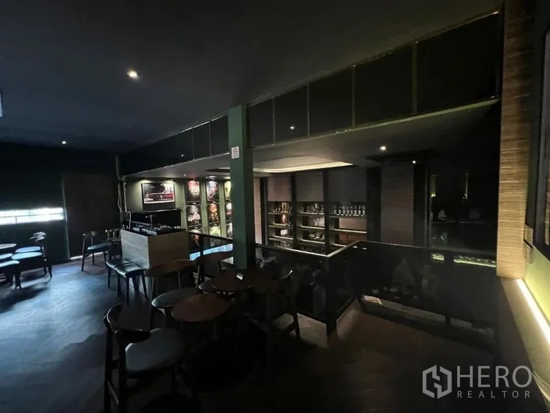 Retail Space for rent in Watthana, Bangkok - Mezzanine-style seating overlooking the bar with display shelves and warm lighting.