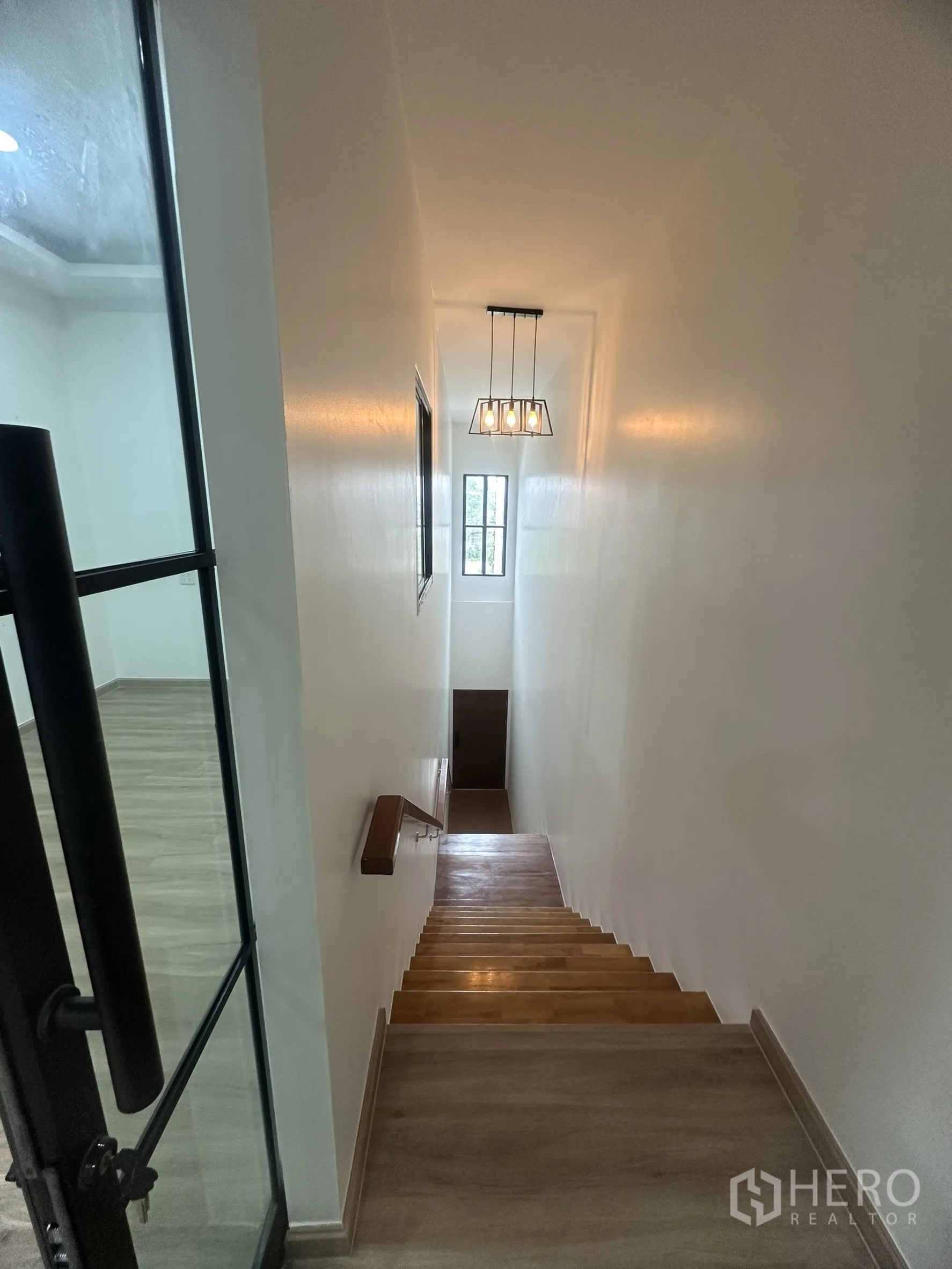 Warehouse for sale in Khlong Luang, Pathum Thani - Straight-run staircase with wooden steps, pendant light and glass office door.