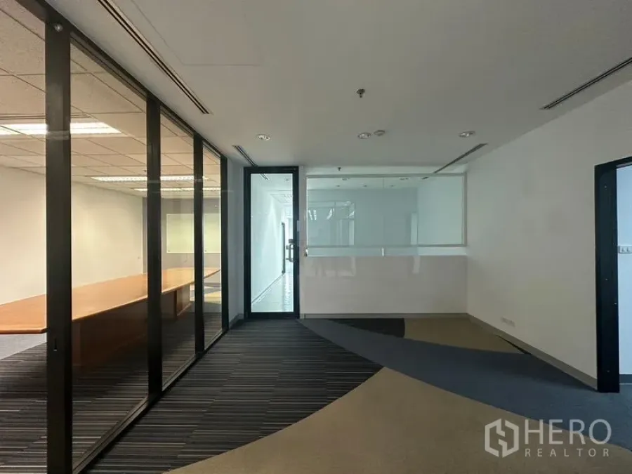 Office Space for rent in Khlong Toei, Bangkok - Entrance corridor with glass partitions and meeting room visible through the panels.