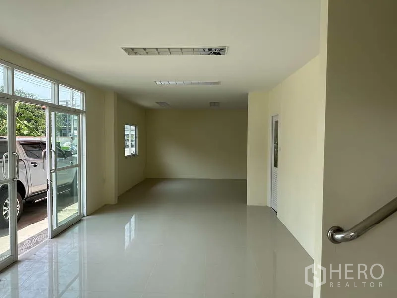 Factory for sale in Mueang Samut Prakan, Samut Prakan - Office lobby with glass entry doors, windows and stair rail leading upstairs.