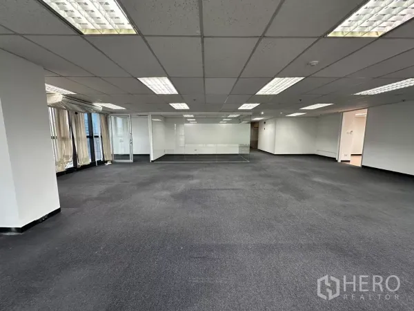 Office Space for rent in Watthana, Bangkok - Open-plan floor with panoramic windows and central glass meeting room under bright ceiling lights.