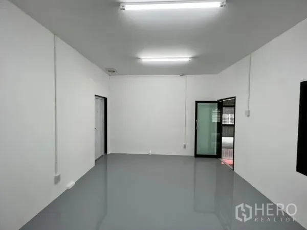 Warehouse for rent in Lat Phrao, Bangkok - Clean office room inside the warehouse with epoxy floor, white walls and LED ceiling lights.
