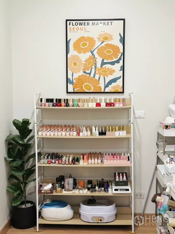 Retail Space for rent - Open shelving stocked with nail polish colors, manicure tools and a floral wall poster.