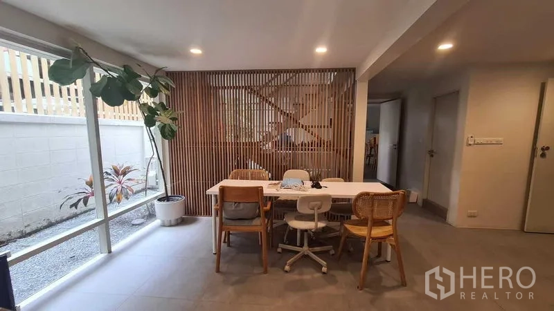 Detached House for rent in Watthana, Bangkok - Flexible workspace or dining area with large window and wood screen.