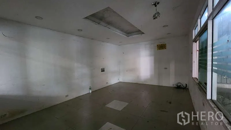 Warehouse for rent in Bang Khen, Bangkok - Empty tiled office space with recessed ceiling lights ready for fit-out.
