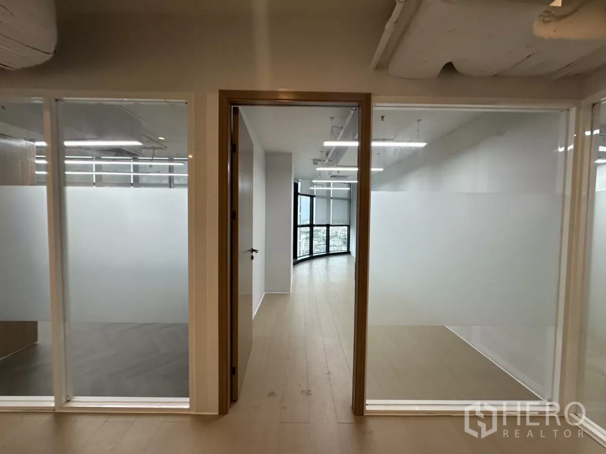 Office Space for rent in Watthana, Bangkok - Glass-framed doorway leading to a curved window corner room.