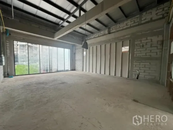 Retail Space for rent - Spacious retail space with high steel-beam ceiling, pendant light and sliding glass wall to natural light.