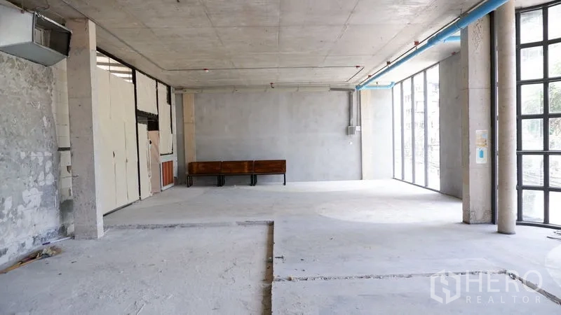 Retail Space for rent in Watthana, Bangkok - Deep rectangular retail space with high ceiling, ducting and full-height glazing bringing natural light.