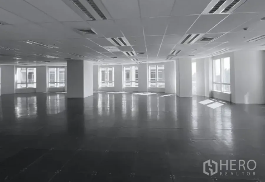 Office Space for rent - Corner office area with large windows, city outlooks, and raised tile flooring under ceiling air vents.