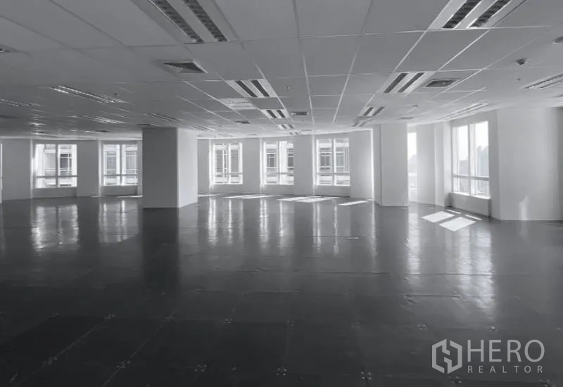 Office Space for rent - Corner office area with large windows, city outlooks, and raised tile flooring under ceiling air vents.