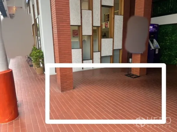 Retail Space for rent - Compact kiosk space marked on terracotta-tiled walkway beside a brick column and ATM, offering prominent frontage.