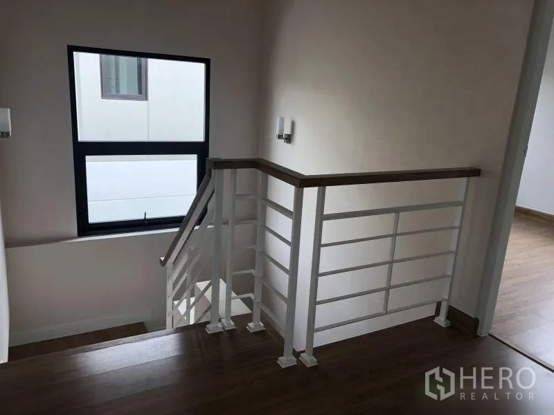 Detached House for sale in Bang Phli, Samut Prakan - Staircase landing with white railing and daylight window