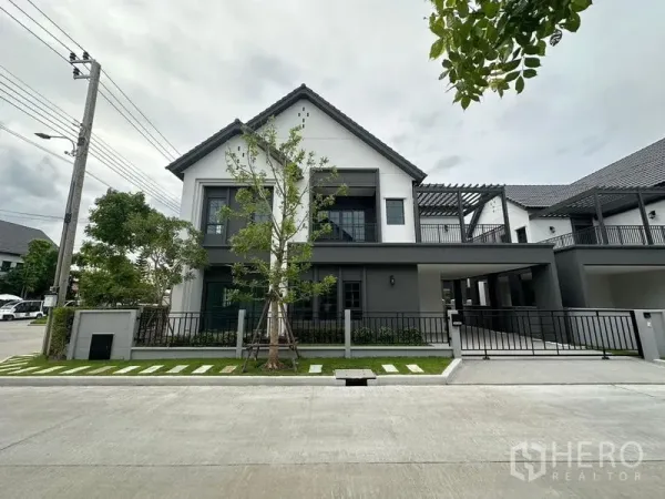 Detached House for rent or sale in Bang Phli, Samut Prakan - Modern two-storey detached house with gabled roof, black fence, driveway and small front garden on a quiet street