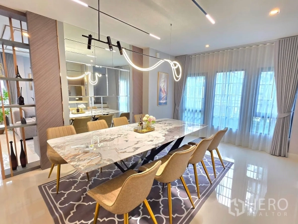 Detached House for rent in Bang Phli, Samut Prakan - Dining room with a marble table for eight and sculptural pendant lighting.