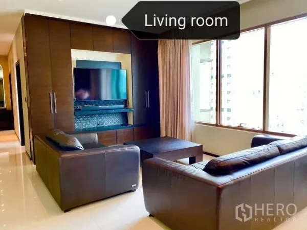 Condominium for rent - Bright living room with leather sofas, built-in TV wall and large city-view windows