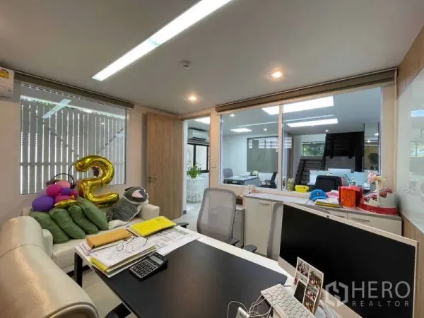 Home Office for rent in Watthana, Bangkok - Private glass-partitioned office with desk overlooking an open workspace.