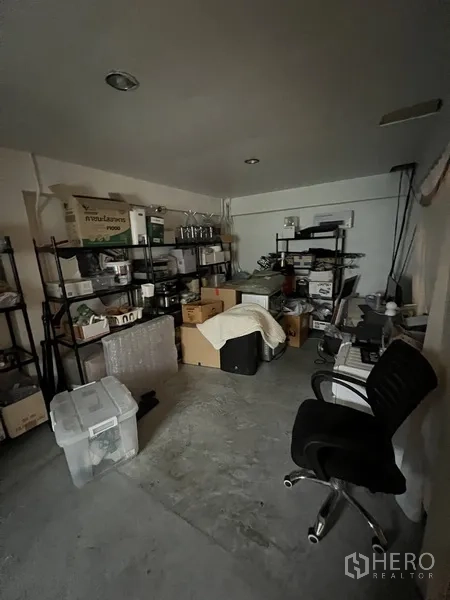 Retail Space for rent in Watthana, Bangkok - Storage room with metal racks, boxes and office chair within the retail premises.