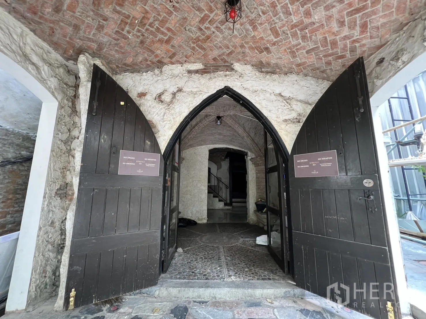 Retail Space for rent in Watthana, Bangkok - Grand entrance with open arched wooden doors and a brick barrel-vaulted ceiling.