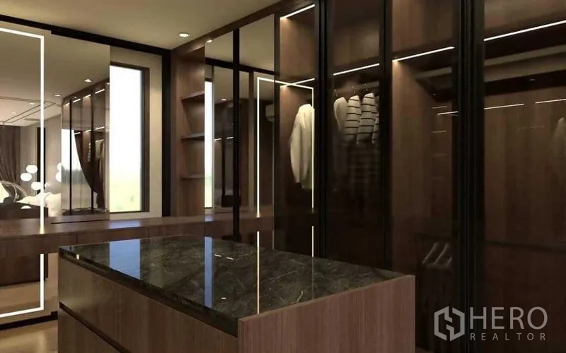 Townhouse for sale in Suan Luang, Bangkok - Close-up of glass-door closets and marble-top island in the dressing room.