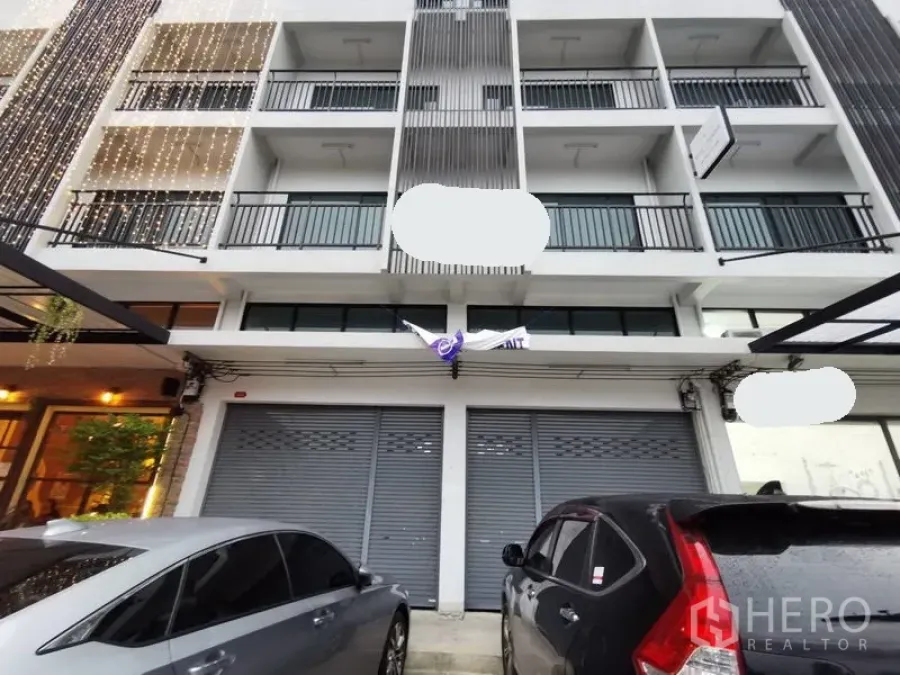 Home Office for rent in Suan Luang, Bangkok - Modern multi-storey home office exterior with balconies and twin roller-shutter frontage, covered parking in front.