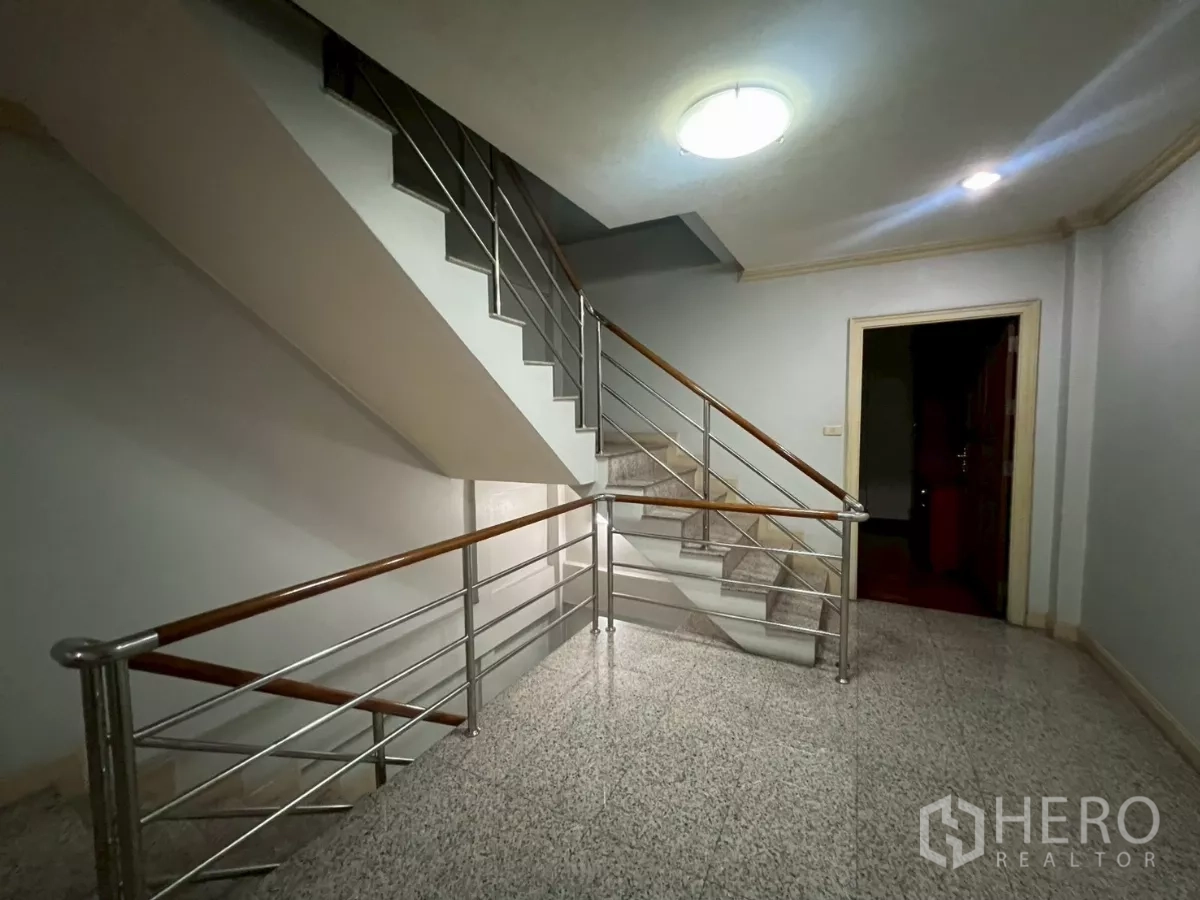 Shophouse for rent in Bang Rak, Bangkok - Stairwell area with stainless rails and granite floors between levels.