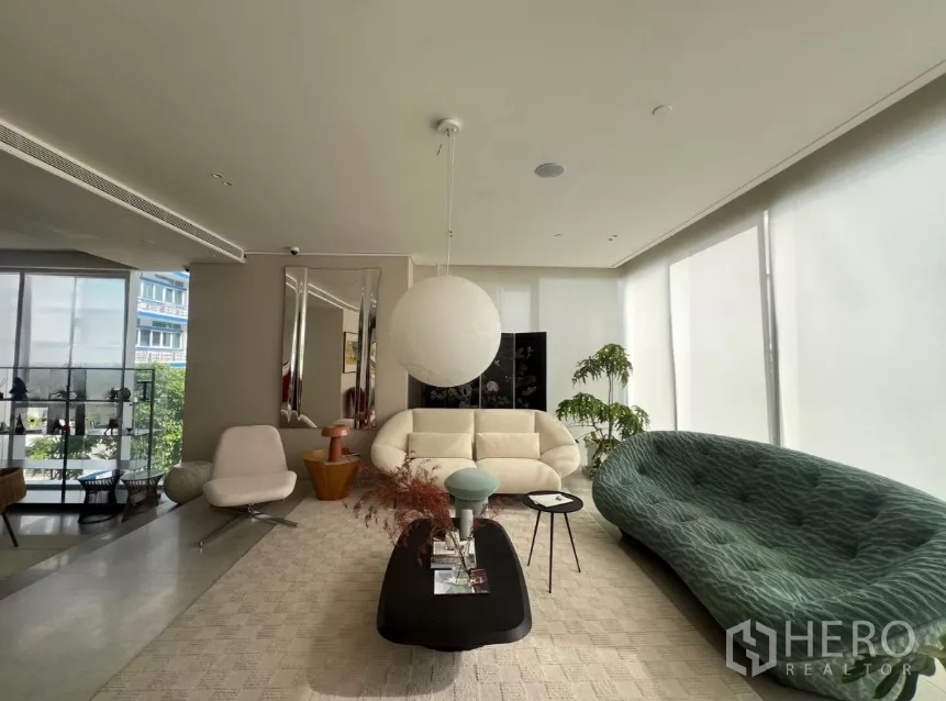 Retail Space for rent - Bright showroom-style seating area with natural light through large windows.