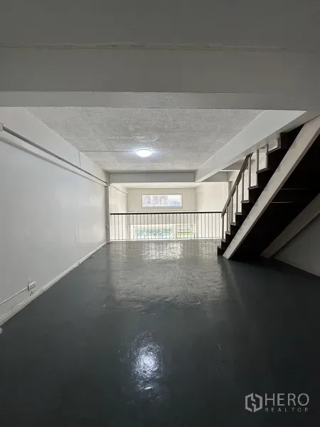 Retail Space for rent in Watthana, Bangkok - Mezzanine level overlooking the shopfront with wooden stairs and railing.