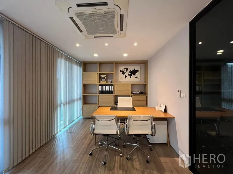 Home Office for rent in Bueng Kum, Bangkok - Executive office with built-in shelving, desk and three chairs.