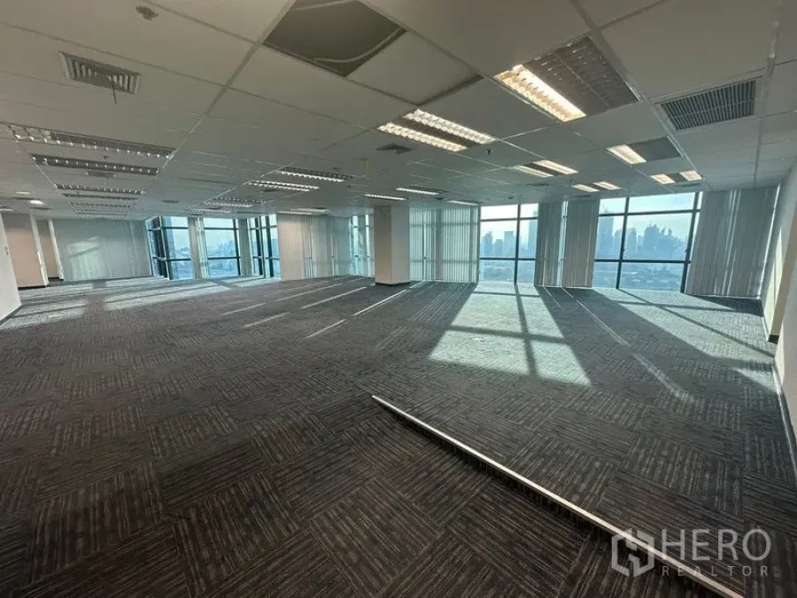 Office Space for rent in Watthana, Bangkok - Expansive open office with suspended ceiling lights and tall glazing facing the skyline.