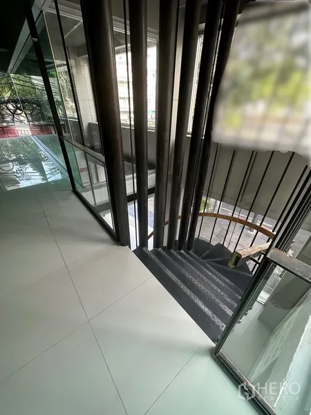 Retail Space for rent in Bang Rak, Bangkok - Internal staircase landing with metal balustrades and floor-to-ceiling windows.