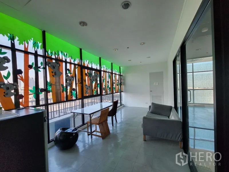 Retail Space for rent in Bang Rak, Bangkok - Lounge or waiting area beside colorful window graphics and balcony access.