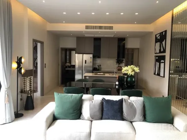 Detached House for sale in Bang Kapi, Bangkok - Modern lounge facing a sleek kitchen with island, recessed lighting and stainless refrigerator.