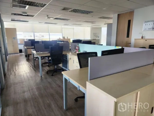 Office Space for rent in Watthana, Bangkok - Open-plan office with multiple workstations, wood flooring, window blinds and abundant natural light.