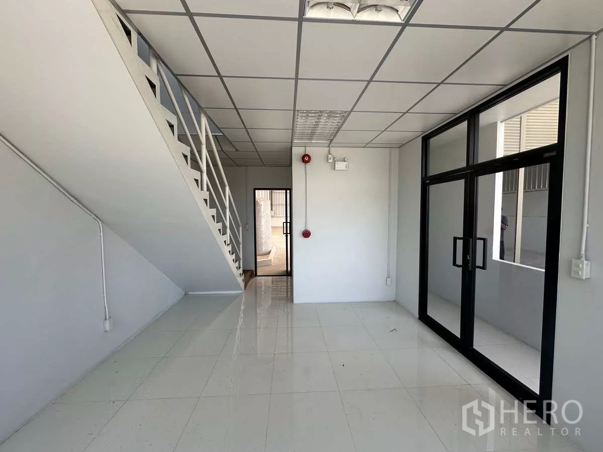 Warehouse for rent in Wang Noi, Phra Nakhon Si Ayutthaya - Ground-floor office lobby with glass doors and a staircase to the second level.