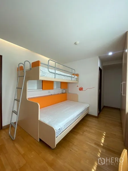 Condominium for rent or sale in Khlong Toei, Bangkok - Kid’s room featuring orange-accented bunk bed with ladder beside a wardrobe.