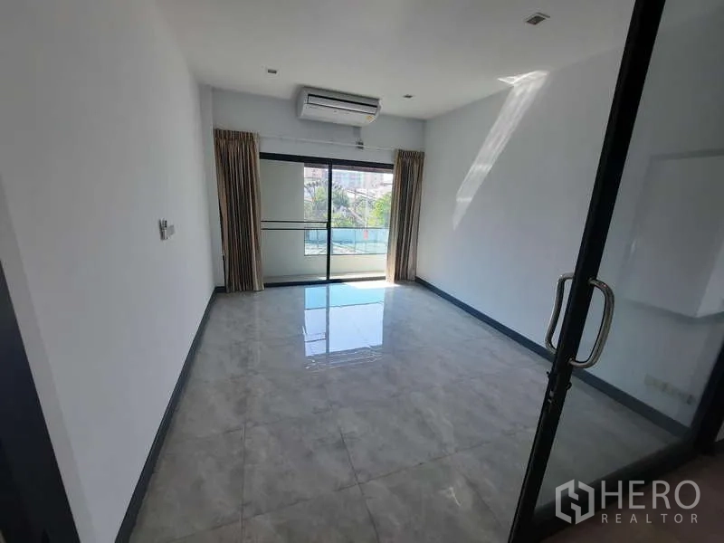Home Office for rent in Huai Khwang, Bangkok - Private office or bedroom with glass doors, air conditioner and balcony view.
