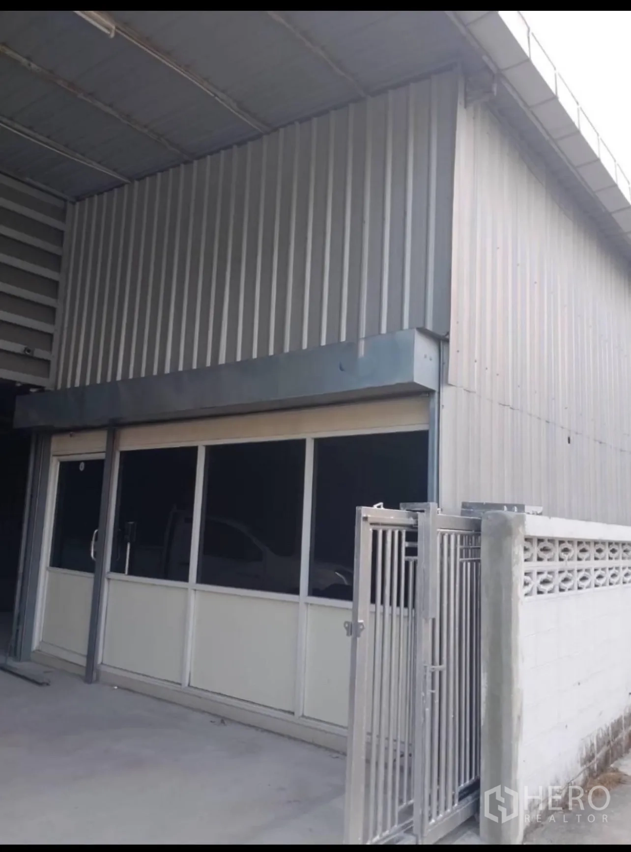 货栈 出租在Din Daeng, Bangkok - 仓库入口配高卷闸门与采光屋面板。
