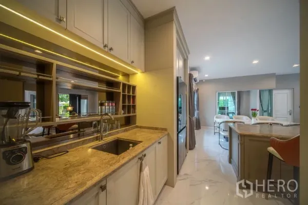 Detached House for rent in Bang Khen, Bangkok - Fully fitted kitchen with island, built-in cabinets, under-cabinet lighting and marble-look floors.